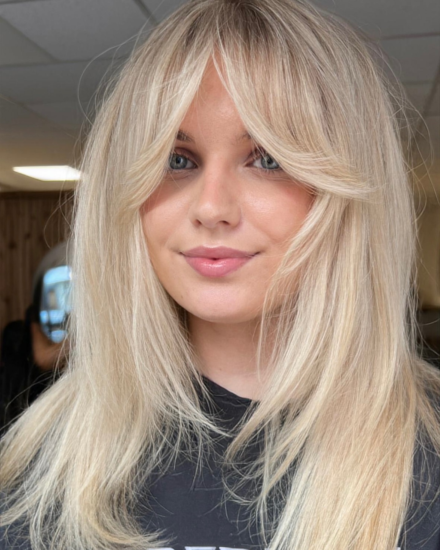 9. Platinum Butterfly Cut with Bottleneck Bangs - Medium-Length Hairstyle Ideas for Women
