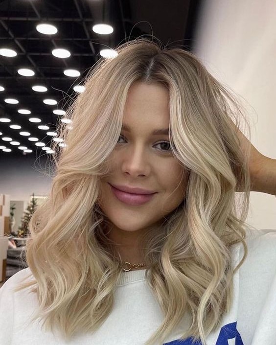 15. Golden Butter Blonde with Loose Waves - Medium-Length Hairstyle Ideas for Women