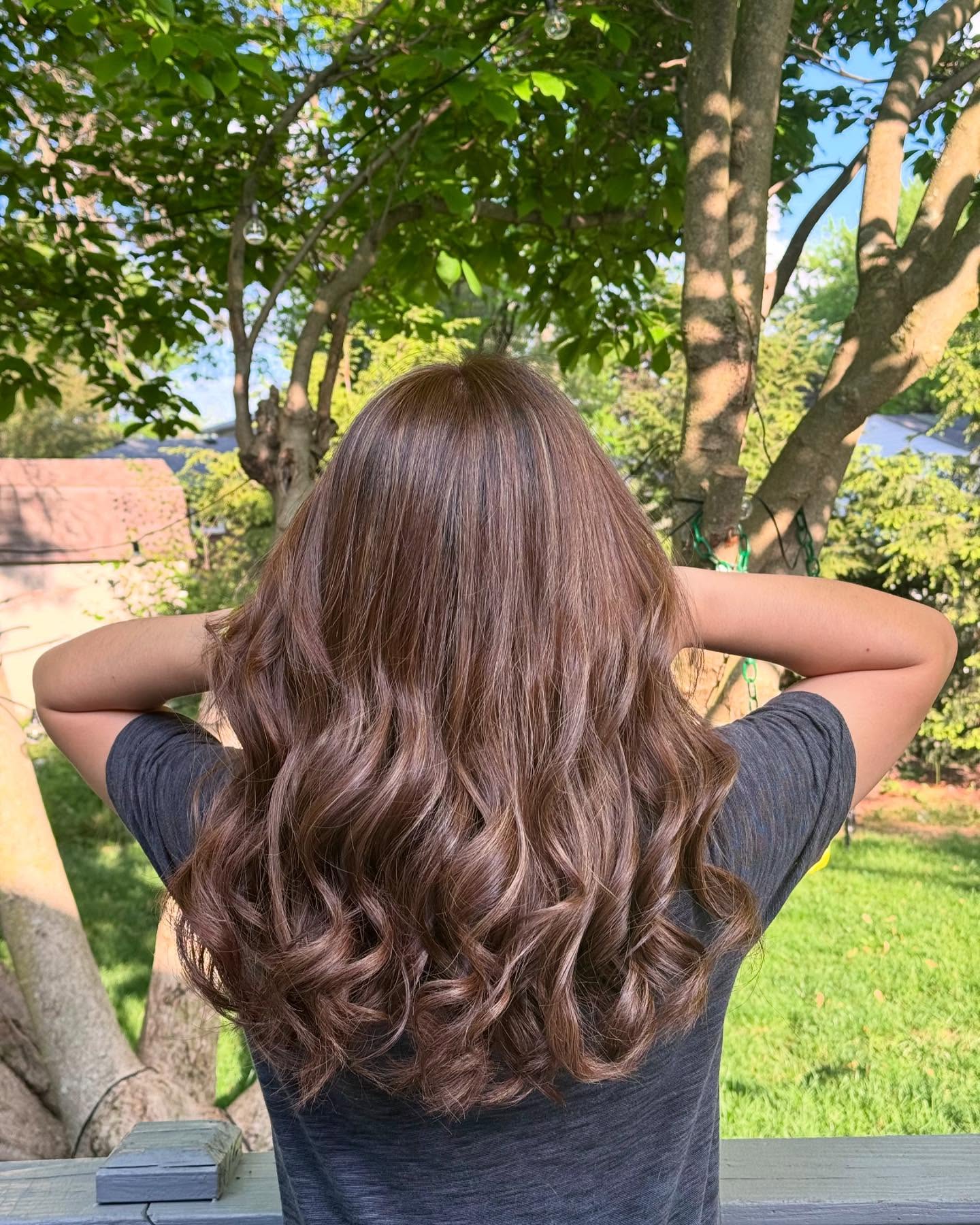 10. Bouncy Cocoa Light Brown Curls with Warm Shine - Light Brown Hair Color Ideas for Women