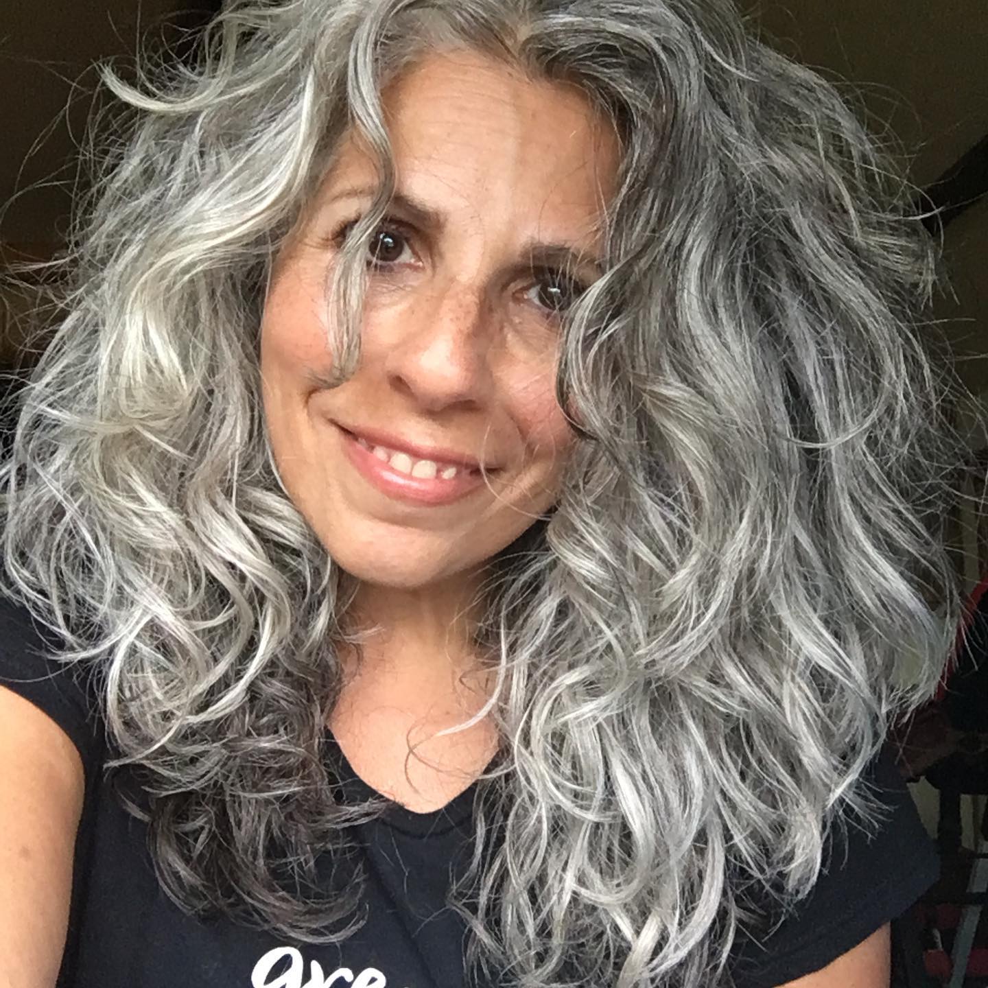 8. Voluminous Curly Gray Style - Hairstyles/Haircuts for Older Women